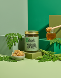 Jungle Wellness Moringa Sea Moss jar with honey and moringa leaves on a green background
